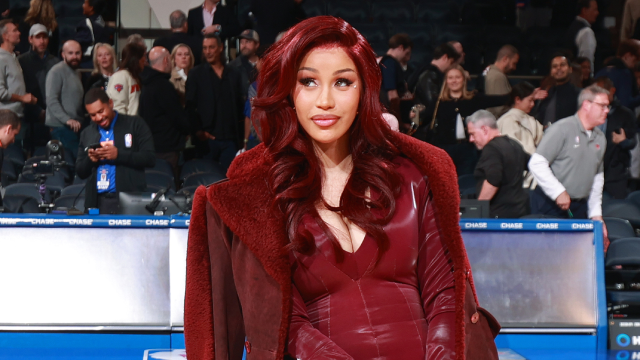 Cardi B with red hair and a matching outfit at the game between the Milwaukee Bucks and the New York Knicks on November 8, 2024 at Madison Square Garden in New York City.