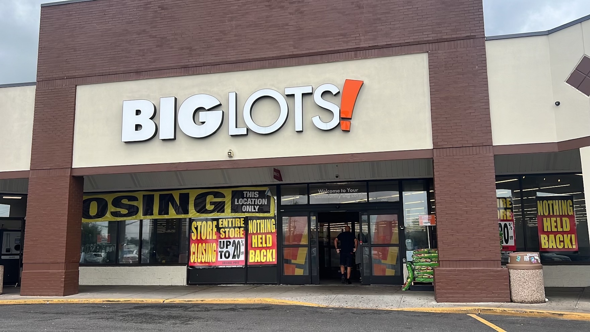 Big Lots store with "Store Closing" signs, advertising discounts up to 20%, and "Nothing Held Back" banners.