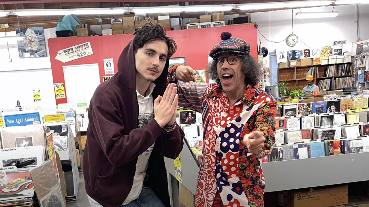 Timothée Chalamet and Nardwuar posing in a record store.