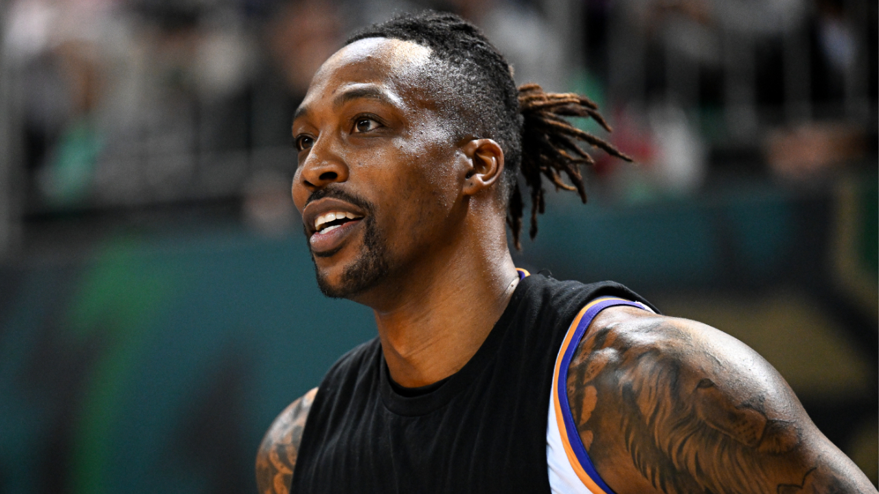 Basketball player Dwight Howard in a sleeveless black shirt, smiling during a game.