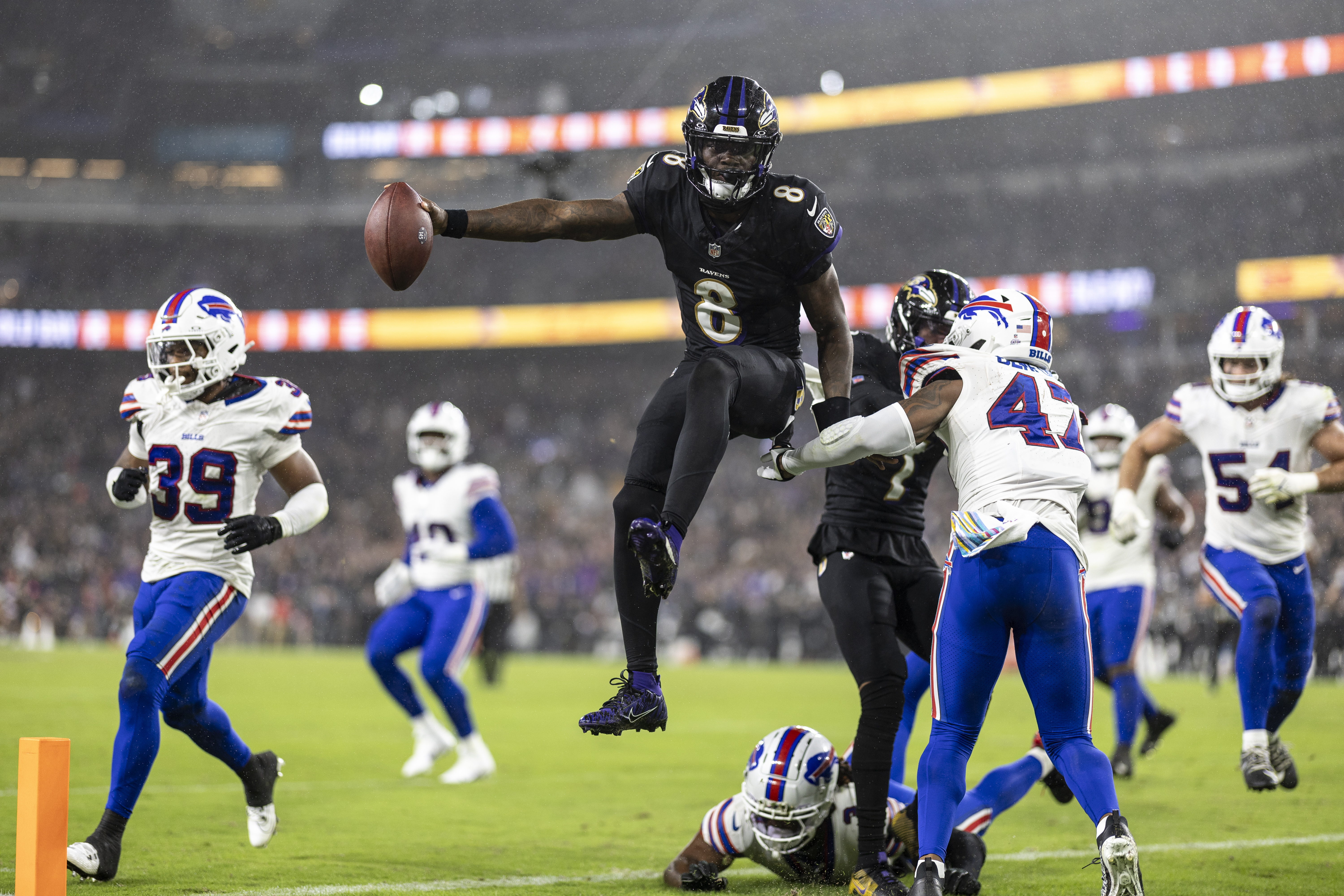 Lamar Jackson #8 of the Baltimore Ravens leaps into the air to score a touchdown against the Buffalo Bills.