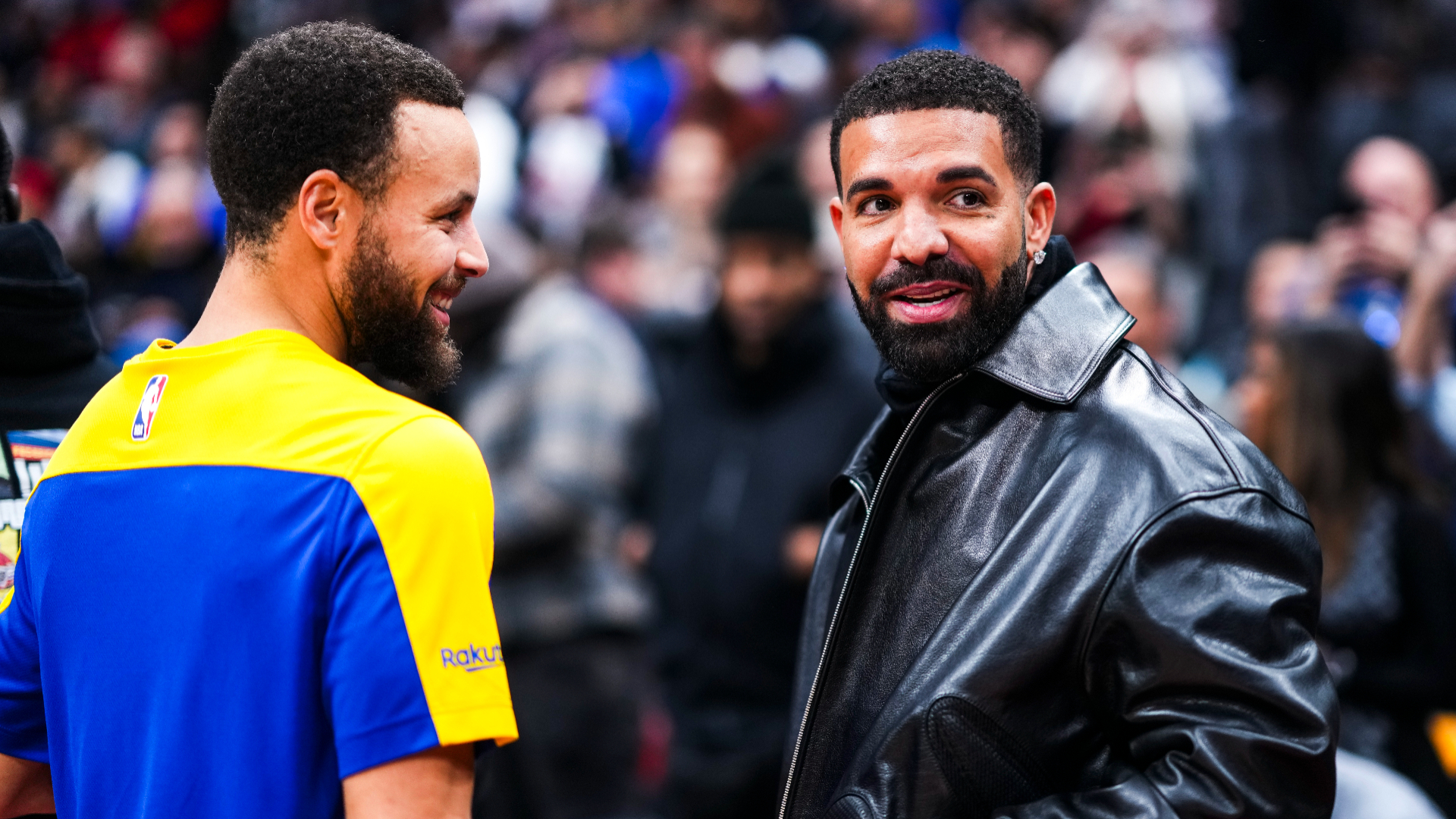 Stephen Curry and Drake at a basketball game.