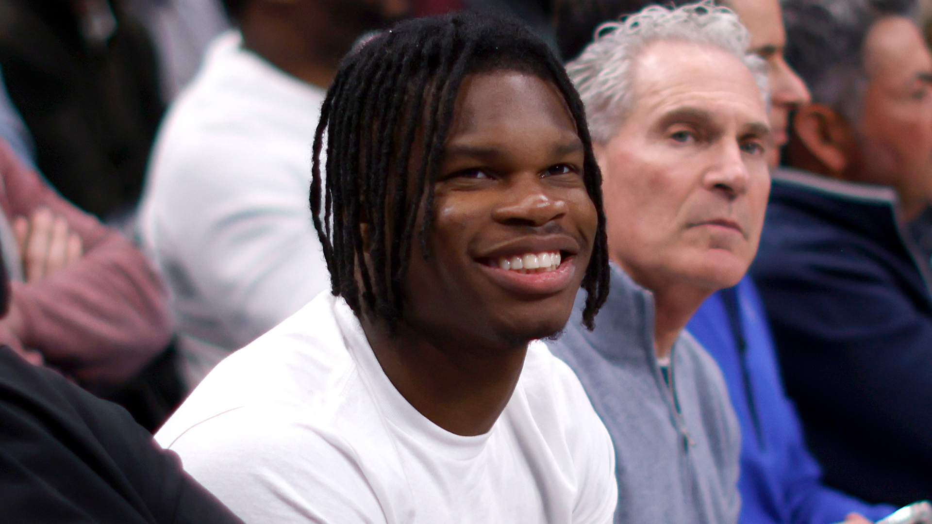Heisman Trophy winner Travis Hunter looks on during the game between the Dallas Mavericks and the Minnesota Timberwolves.