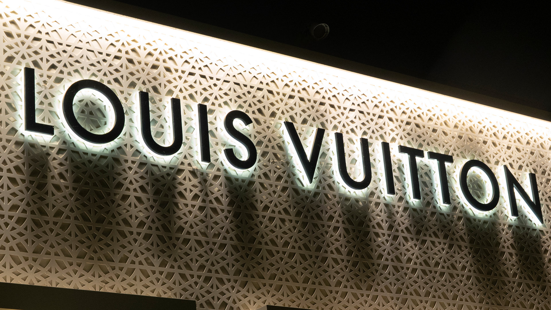 A Louis Vuitton corporate logo hangs on the front of their store at the Westfield UTC shopping center in San Diego, California.