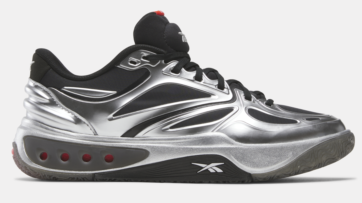 A metallic silver and black Reebok Engine A sneaker with red accents and a futuristic design.