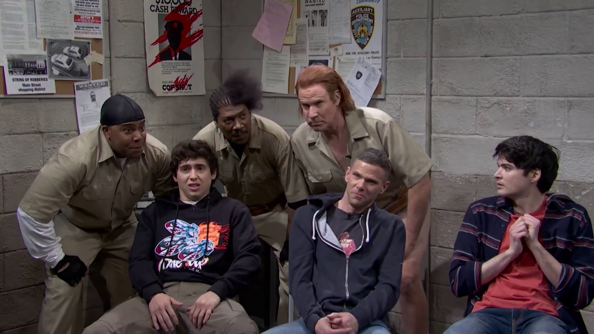 'SNL50' skit set in a police station with actors in uniforms and casual clothes.