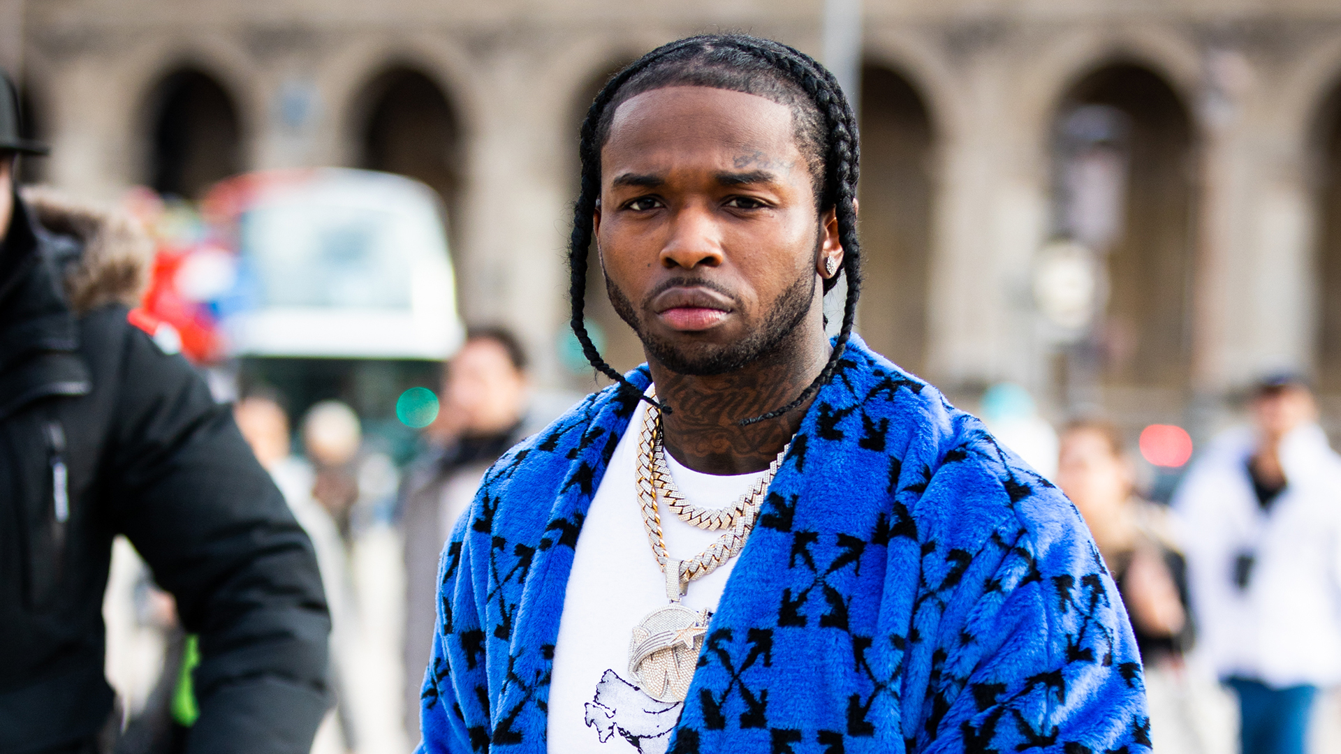 Rapper Pop Smoke, wearing a blue Off-White coat, is seen outside the Off-White show during the Paris Fashion Week