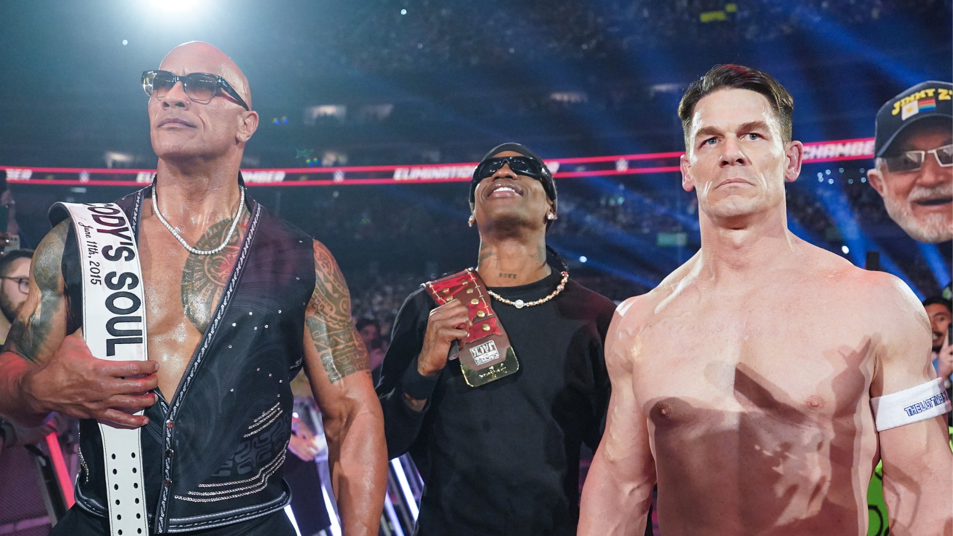 Dwayne "The Rock" Johnson, Bad Bunny, and John Cena at a wrestling event, with The Rock in a vest, Bad Bunny holding a belt, and Cena shirtless.