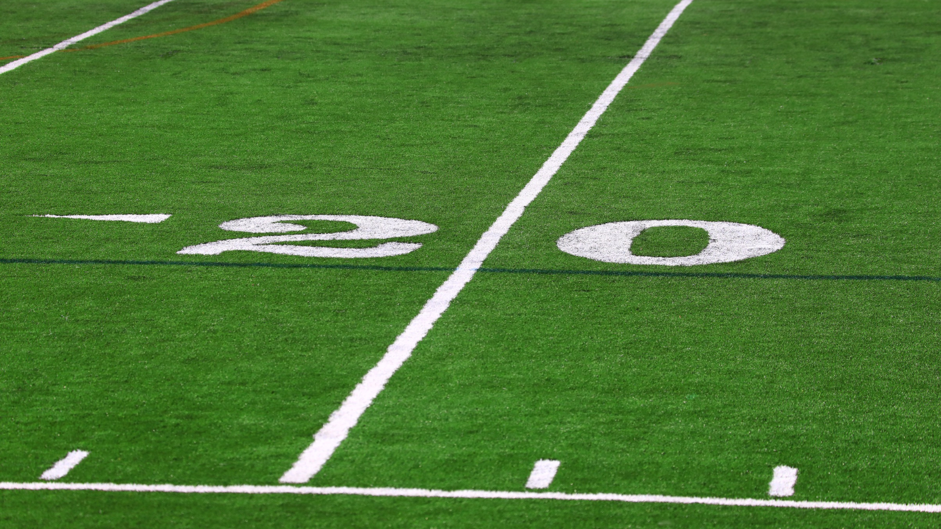 Twenty yard line and marker painted on the football field.
