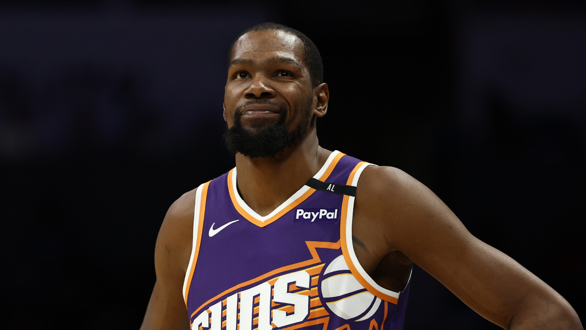 Kevin Durant in a Phoenix Suns jersey, looking confident on the basketball court.