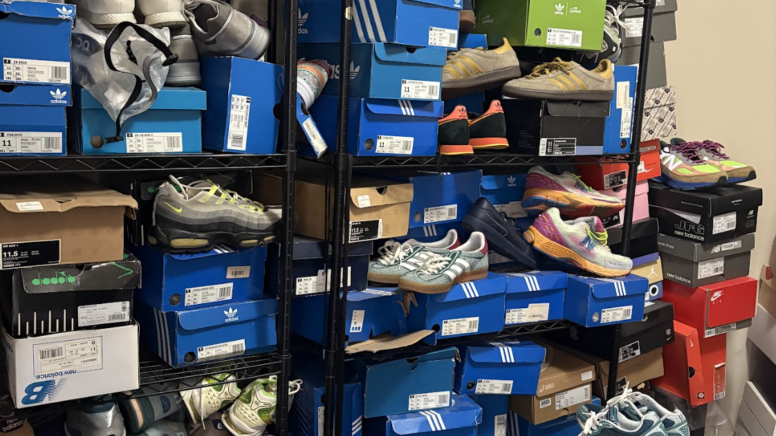 Shelves filled with various sneakers and shoe boxes, including brands like Adidas and New Balance. Shoes are stacked and organized.