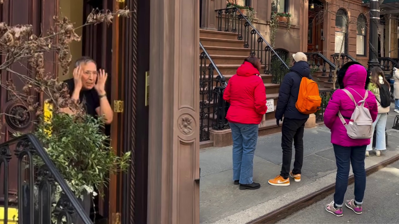 A person peeks out of a brownstone door on the left, while a group of people stand on the sidewalk on the right, dressed warmly.