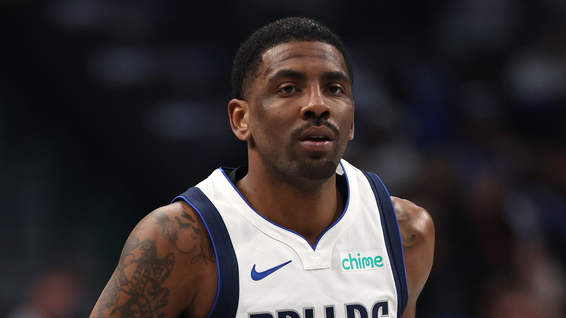 A basketball player in a Dallas Mavericks jersey on the court.