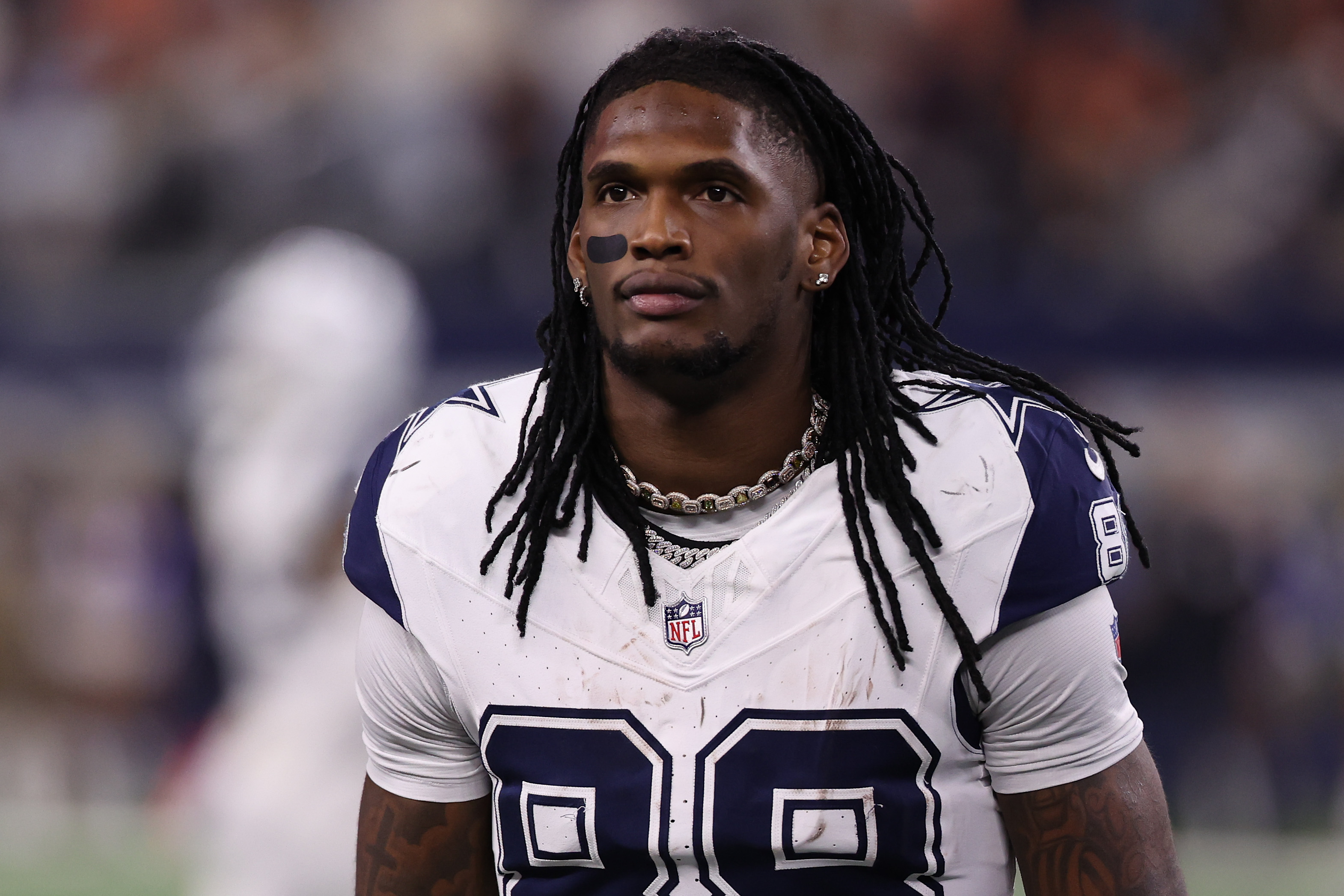 CeeDee Lamb in a Dallas Cowboys uniform, wearing jersey number 88, stands on the field with a focused expression.