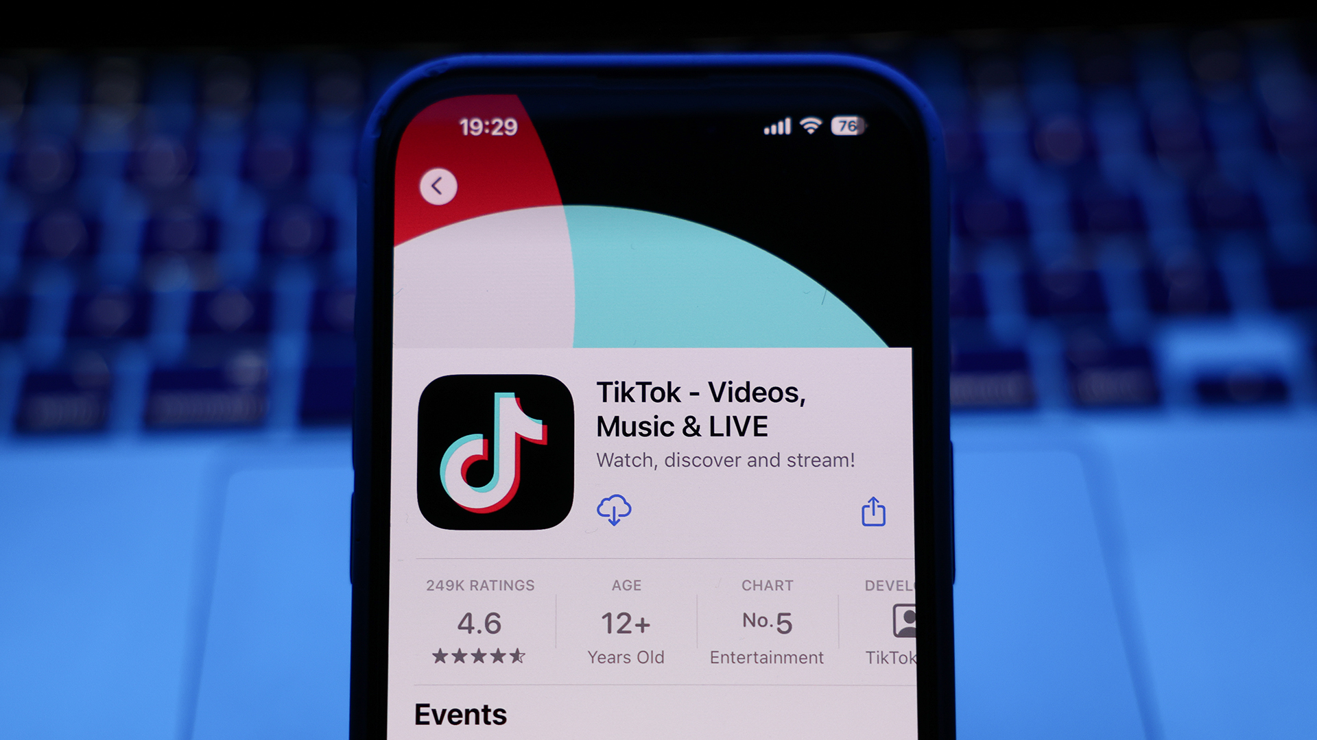 A smartphone displaying the TikTok app page in an app store, with ratings and age information visible.