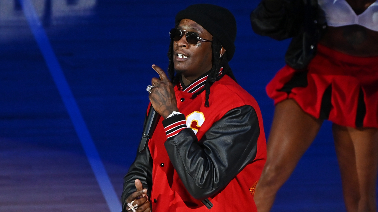 A tweet from Young Thug saying, \Yall mfers goin have to beg me to drop this shit nocizzy,\ with a reply, \U NOT CARTI LIL BRA,\ from another user.
