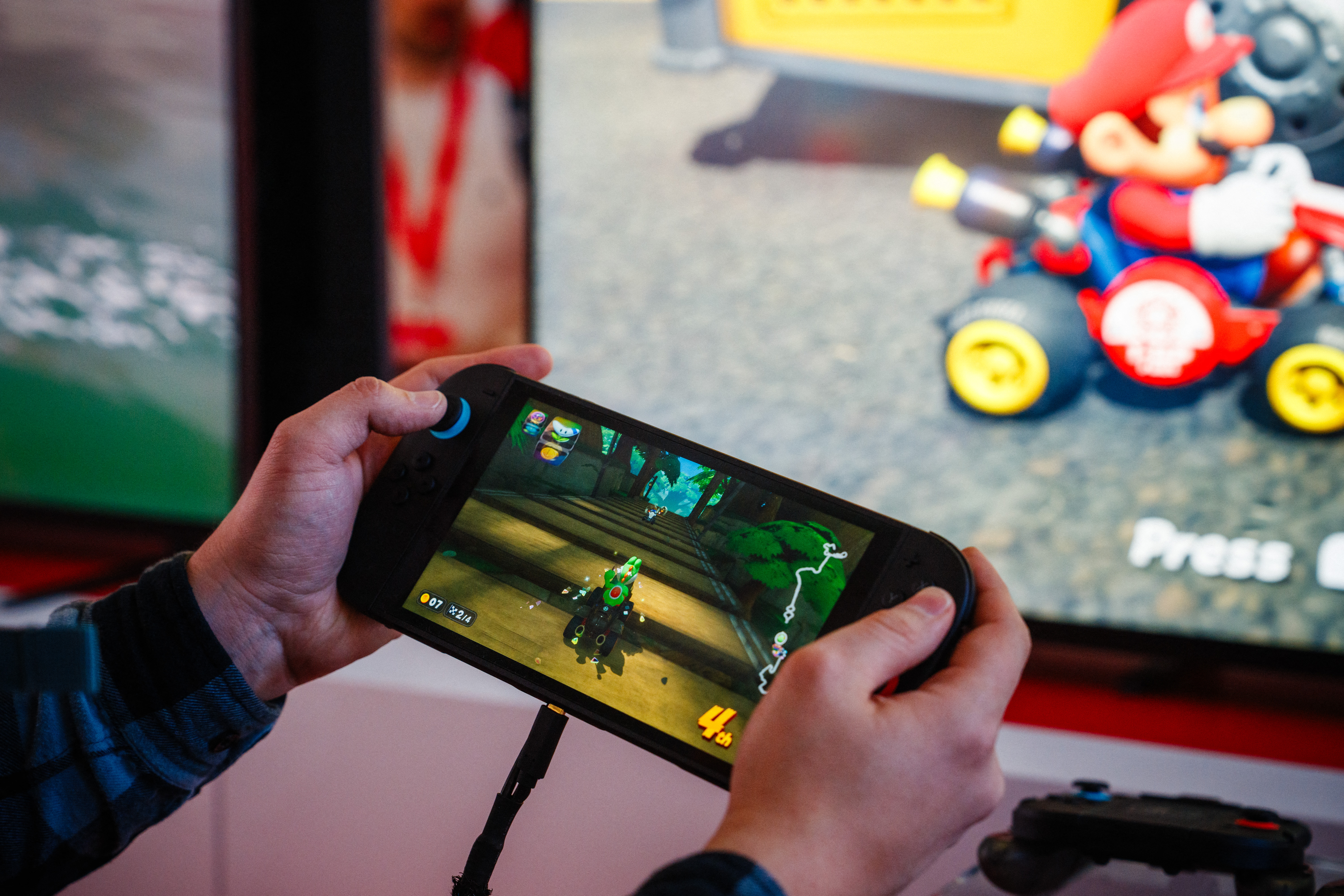 A guest plays Mariokart World of the new Nintendo Switch 2 video-game console system of Japanese video-game company Nintendo during the worldwide presentation at the Grand Palais in Paris on April 2, 2025. Japanese video game giant Nintendo announced on April 2, 2025, that the new version of its Switch console would be launched on June 5, 2025. The Kyoto-based company also revealed new features for the Switch 2 -- an update to the 2017 original model -- including a new chat button that allows players to speak with each other while playing.