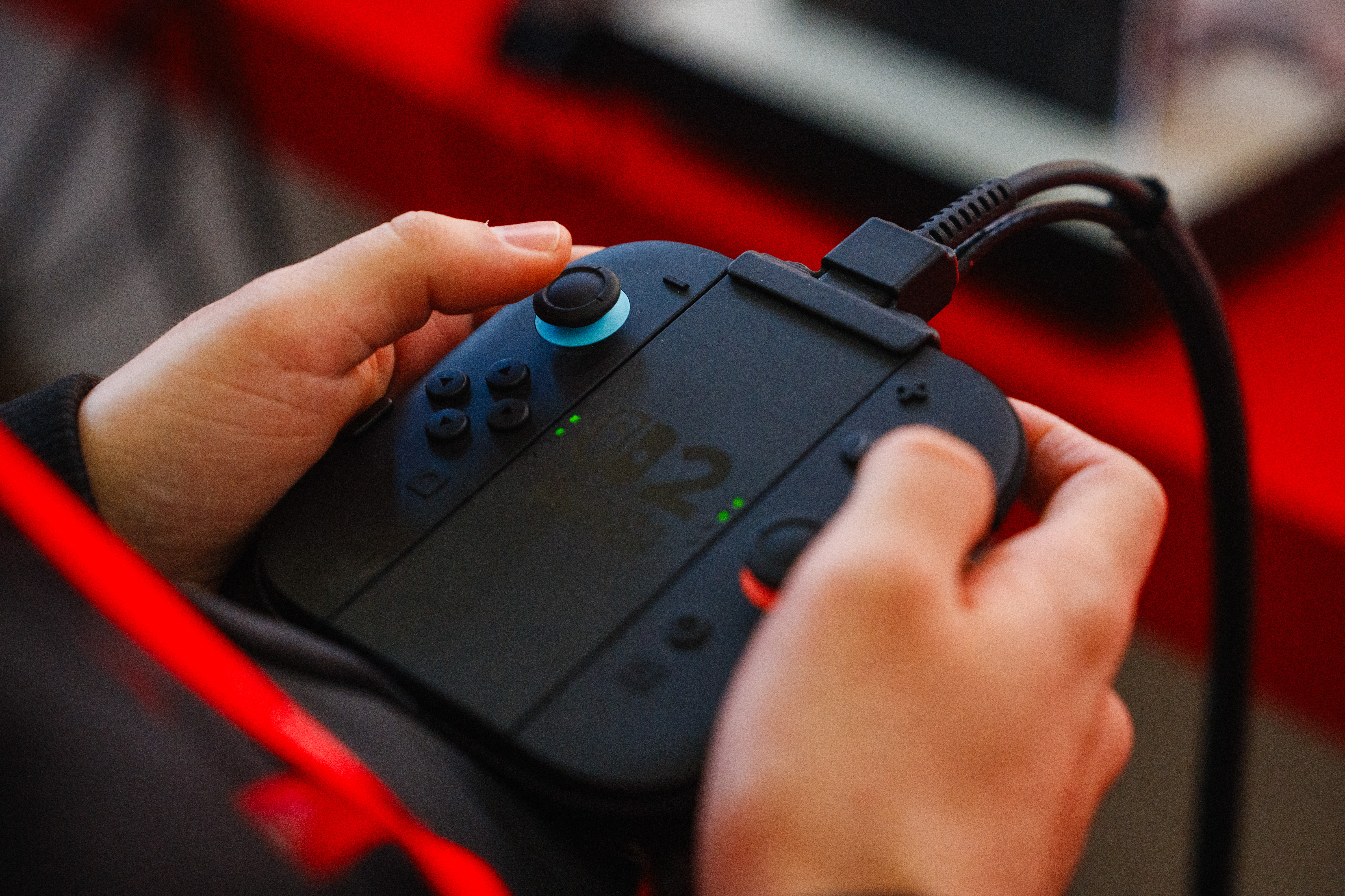 A guest holds the detachable Joy-con controllers of the new Nintendo Switch 2 video-game console system of Japanese video-game company Nintendo during the worldwide presentation at the Grand Palais in Paris on April 2, 2025. Japanese video game giant Nintendo announced on April 2, 2025, that the new version of its Switch console would be launched on June 5, 2025. The Kyoto-based company also revealed new features for the Switch 2 -- an update to the 2017 original model -- including a new chat button that allows players to speak with each other while playing.