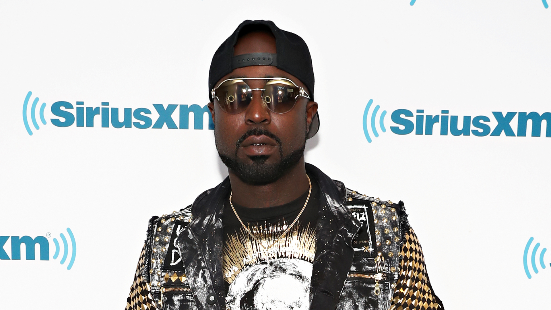 Young Buck poses in front of a SiriusXM backdrop.