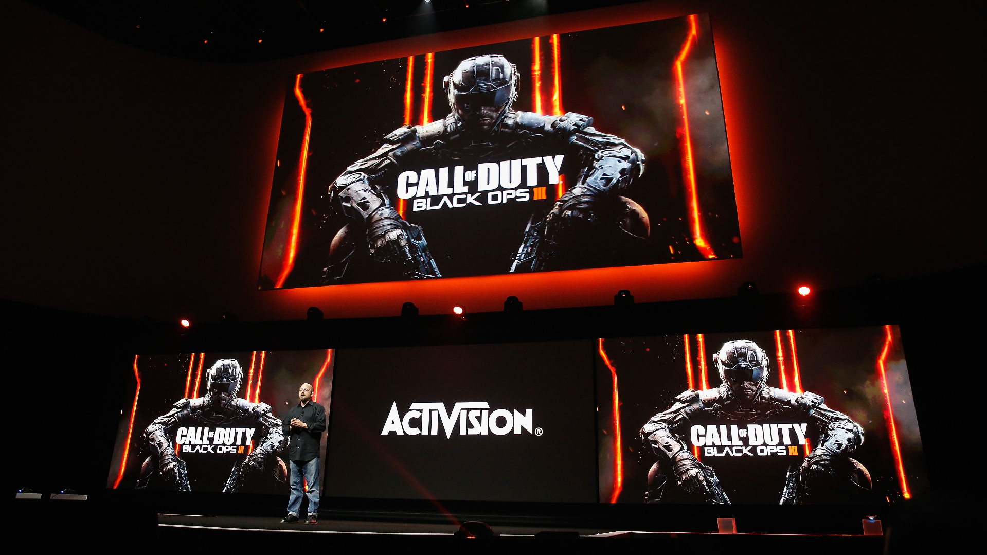 A person stands on stage at a gaming event with "Call of Duty: Black Ops III" displayed on screens, alongside the Activision logo.