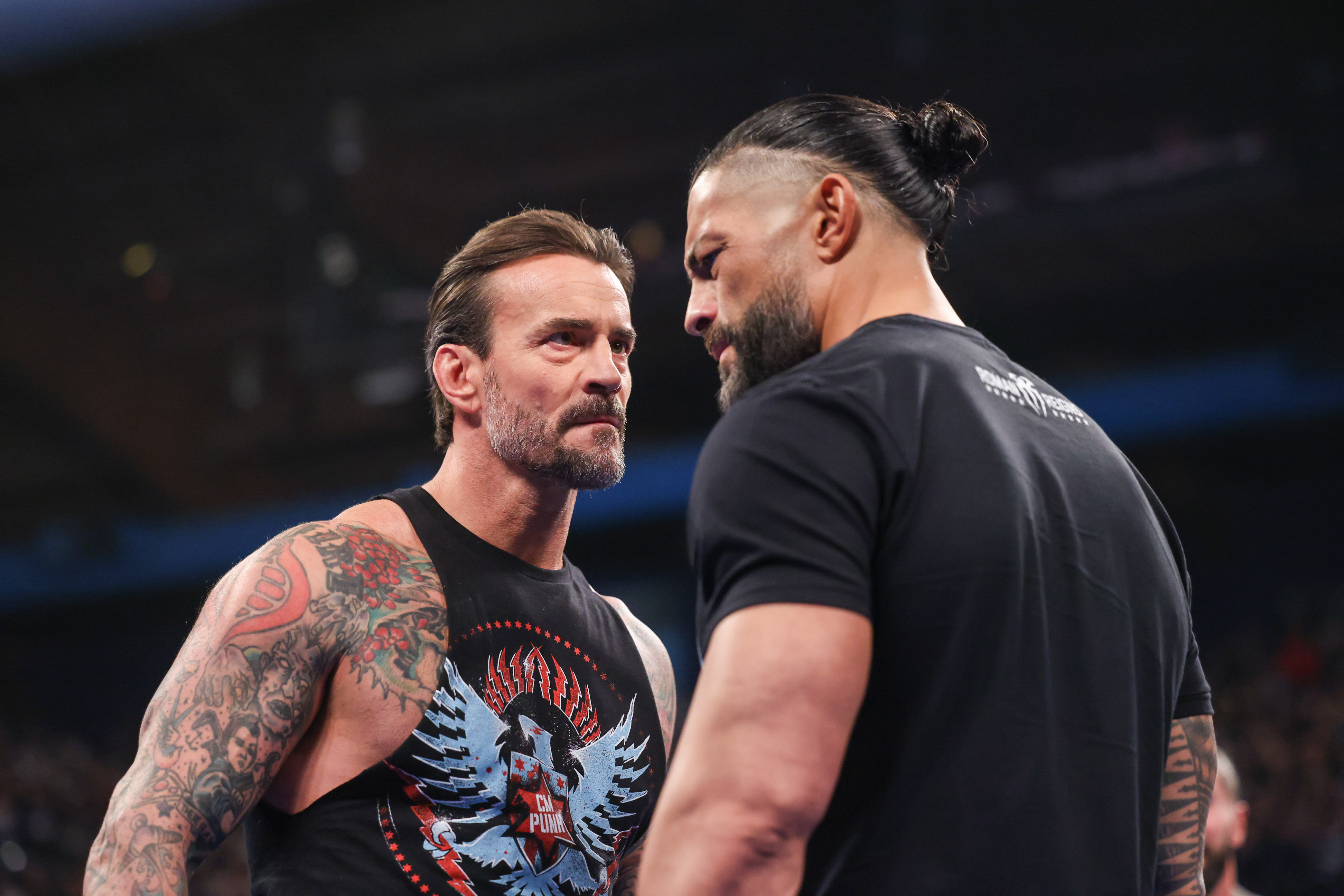 ROSEMONT, ILLINOIS - APRIL 4: CM Punk and Roman Reigns face off during SmackDown at Allstate Arena on April 4, 2025 in Rosemont, Illinois.