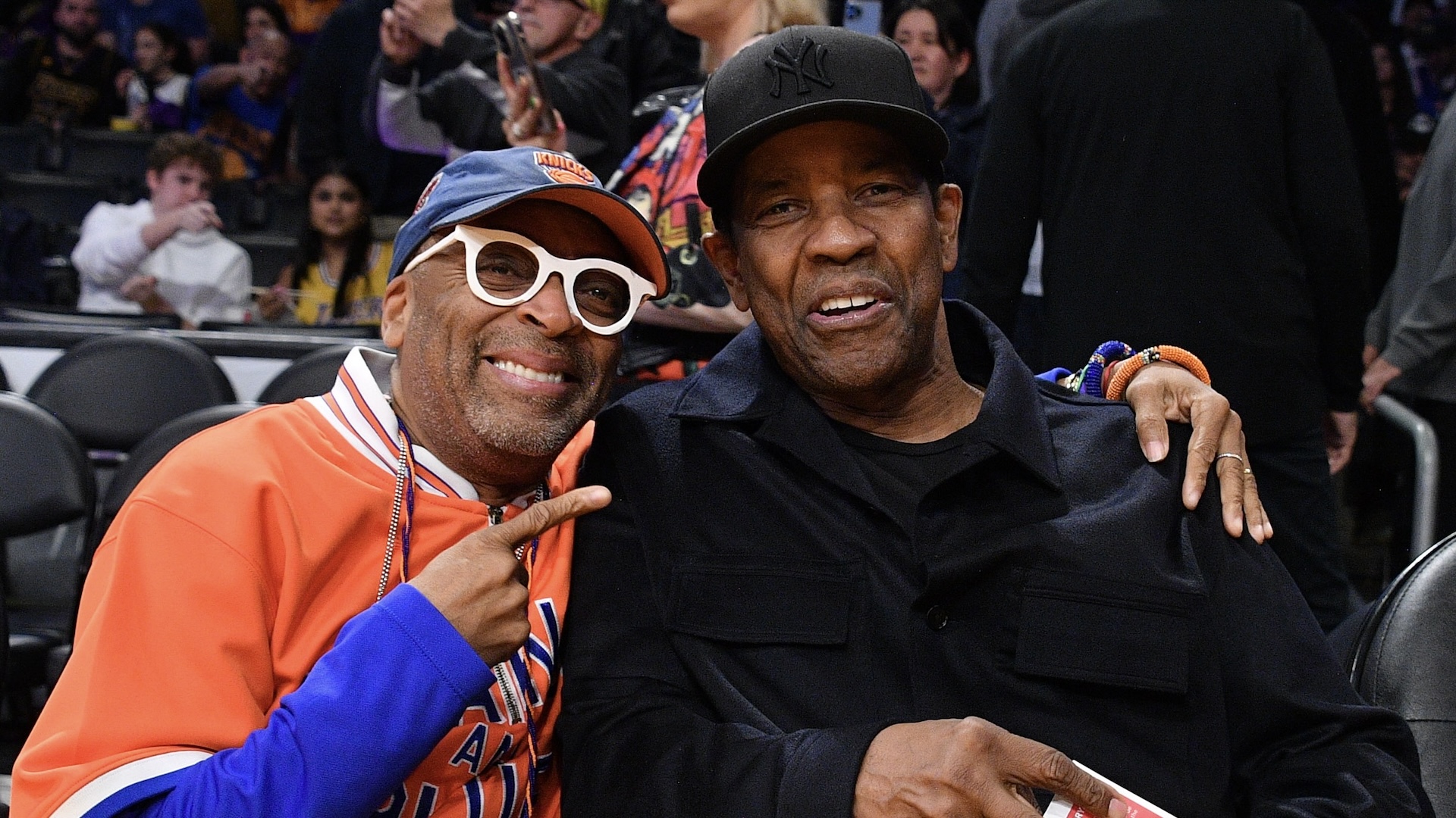 Spike Lee (L) and Denzel Washington attend a basketball game between the Los Angeles Lakers and the New York Knicks
