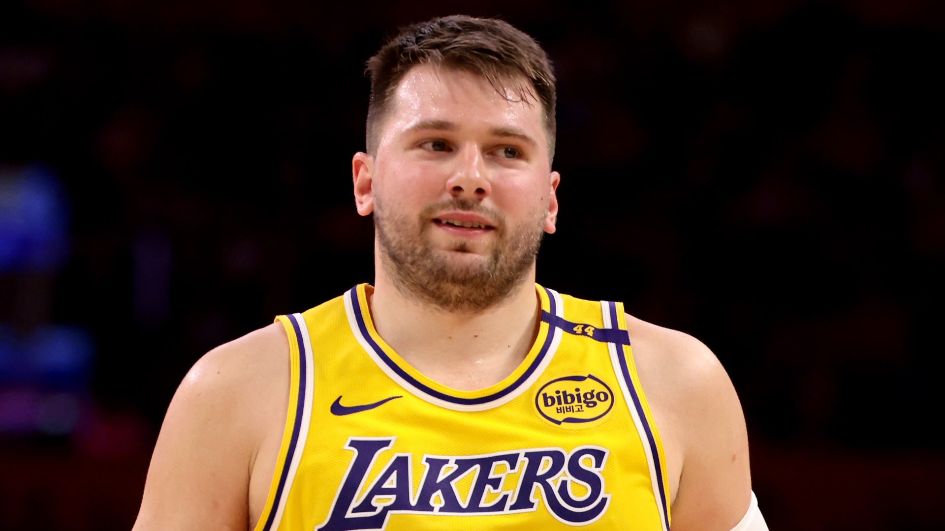 A basketball player in a Lakers jersey on the court.