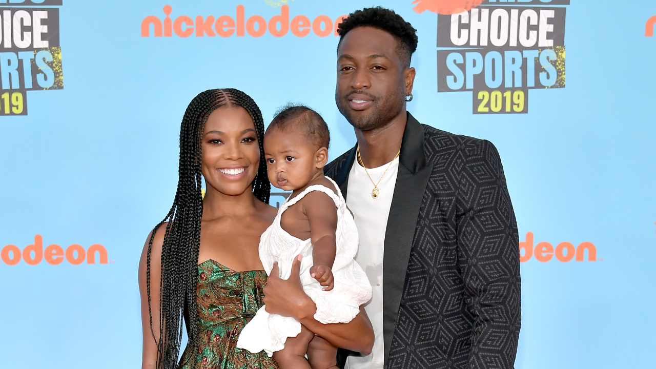 Gabrielle Union and Dwyane Wade, holding their child, at the Nickelodeon Kids' Choice Sports 2019 event.