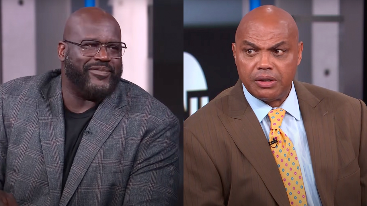 Shaquille O'Neal and Charles Barkley are in a studio setting. Shaq is wearing glasses and a plaid jacket; Barkley is in a brown suit.