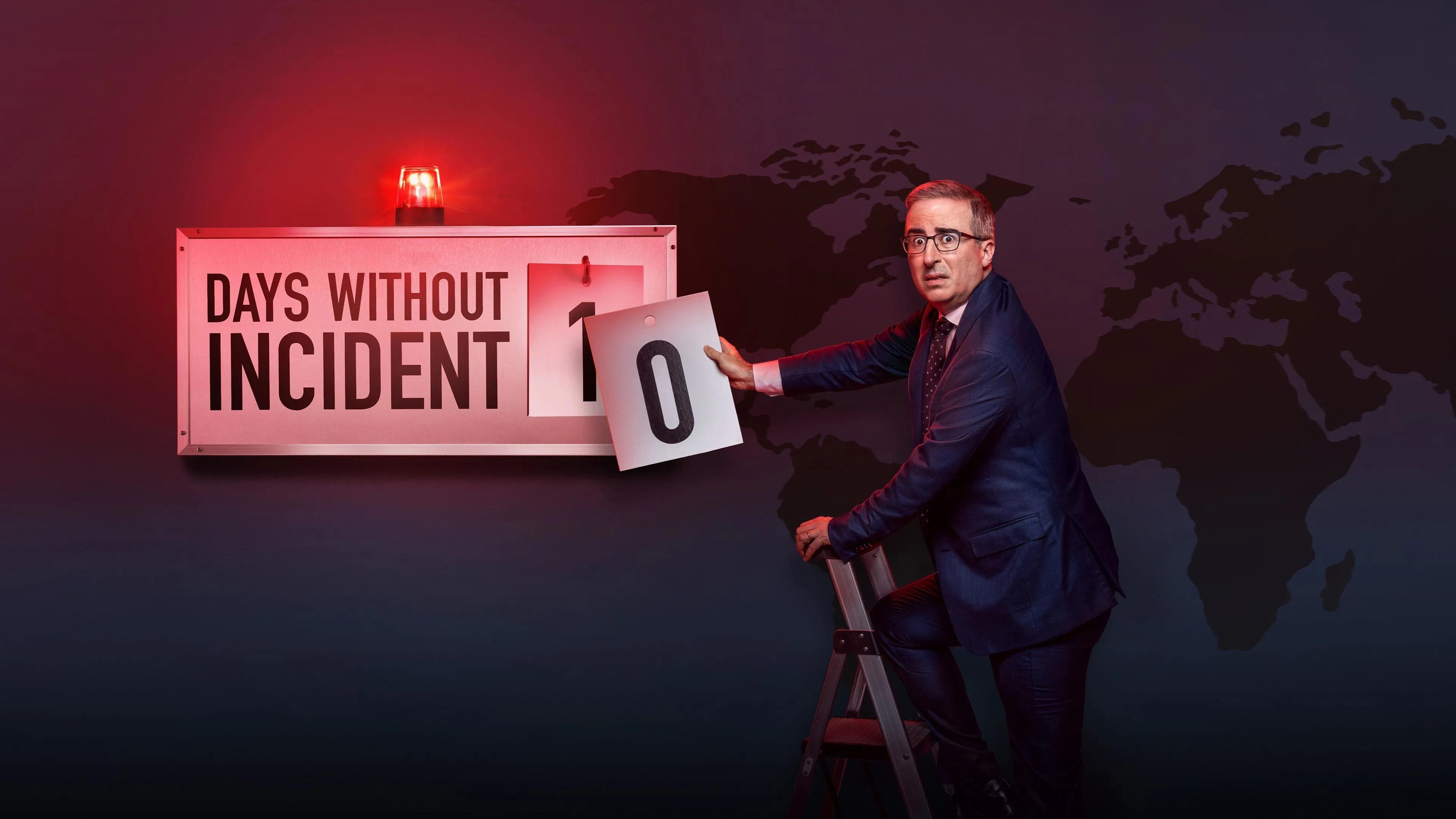 A man in a suit stands on a ladder, changing a sign reading "Days Without Incident" to 0, with a world map in the background.