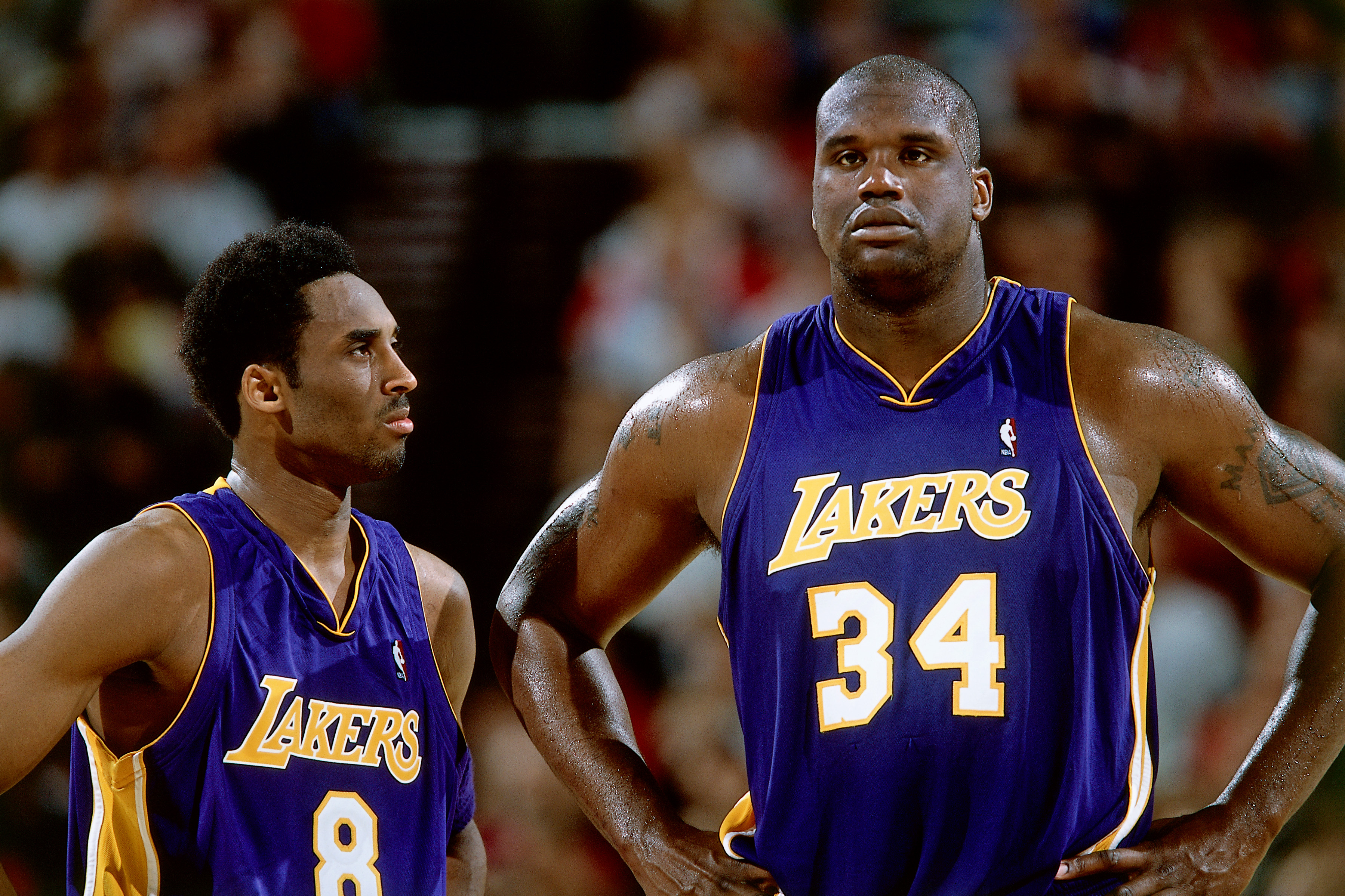 Kobe Bryant and Shaquille O'Neal look on during a Lakers game 
