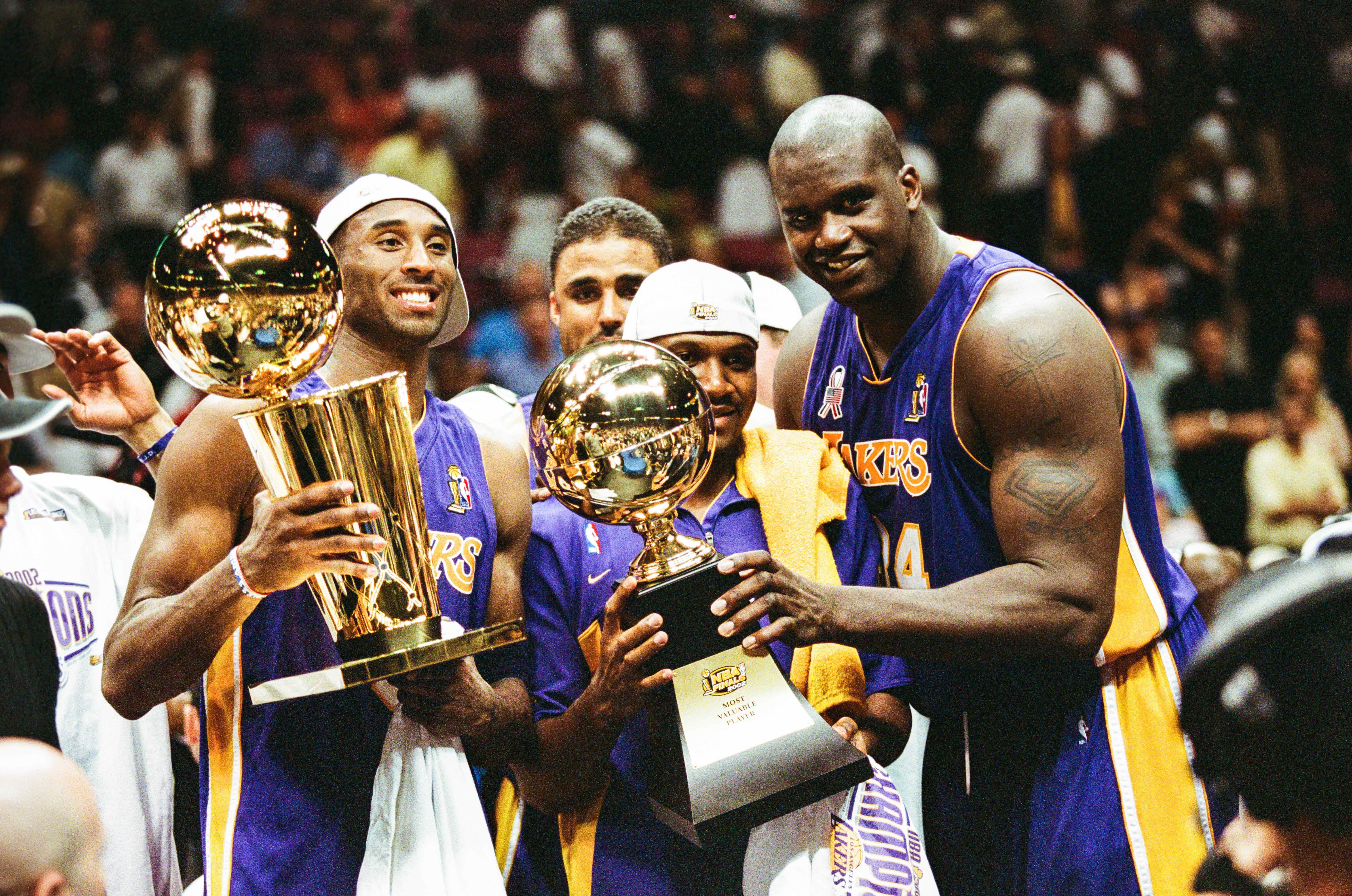 Kobe Bryant, Rick Fox, Lindsey Hunter, and Shaquille O'Neal celebrate the Lakers third consecutive championship in June 2002.