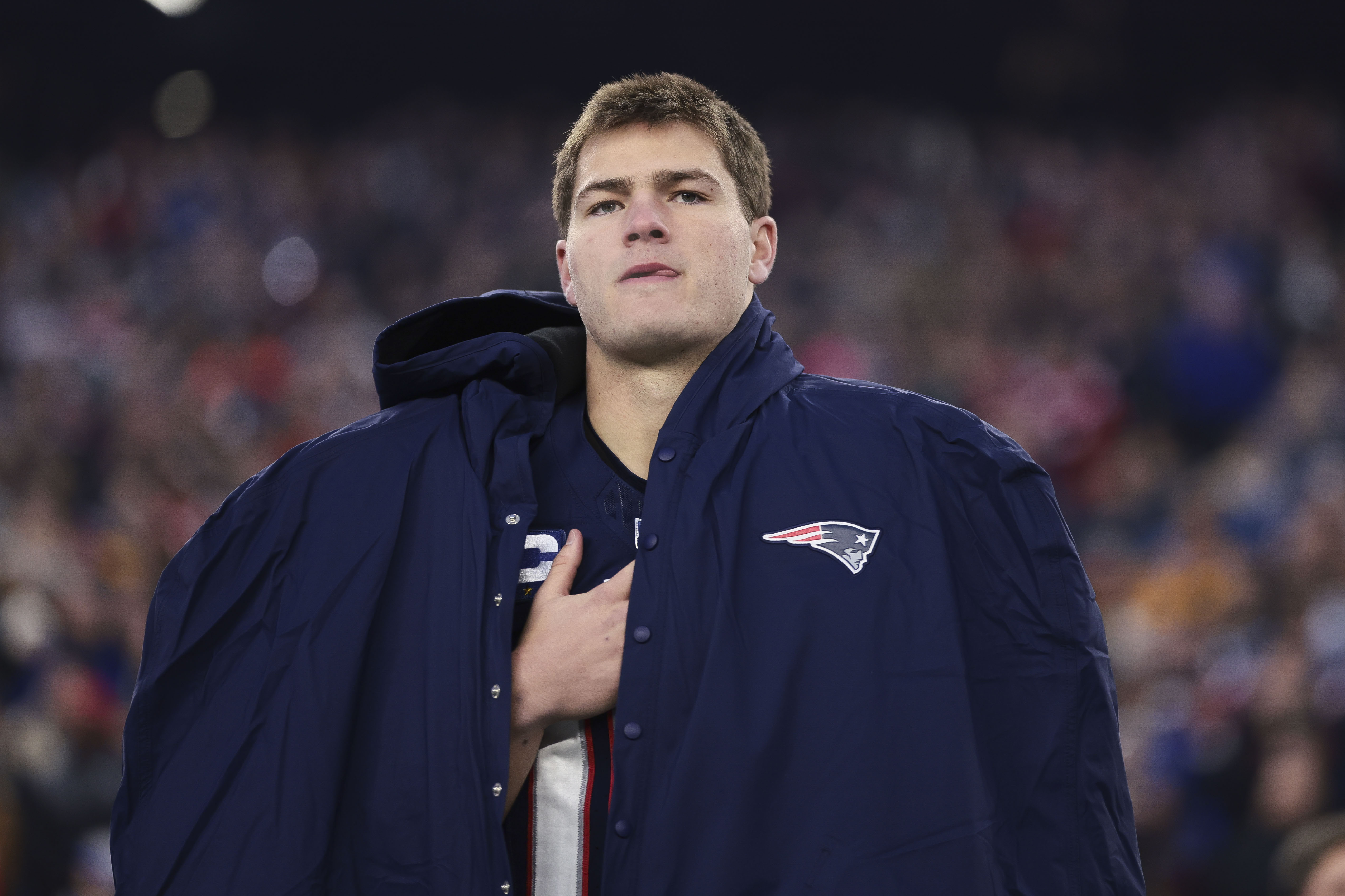 Drake Maye stands for the national anthem before the Patriots-Dolphins game.