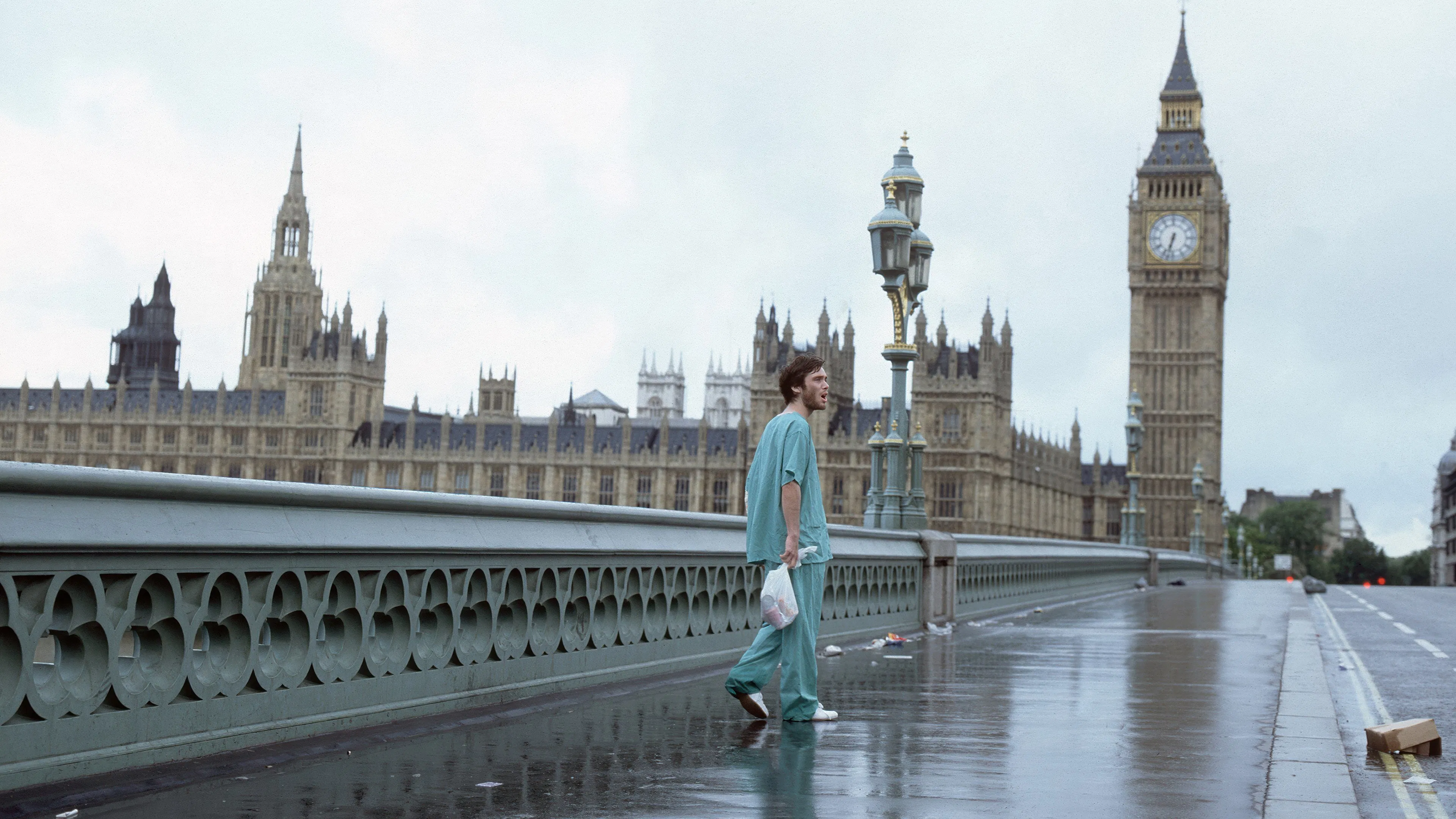 A person in scrubs walks on an empty Westminster Bridge with Big Ben and the Houses of Parliament in the background.