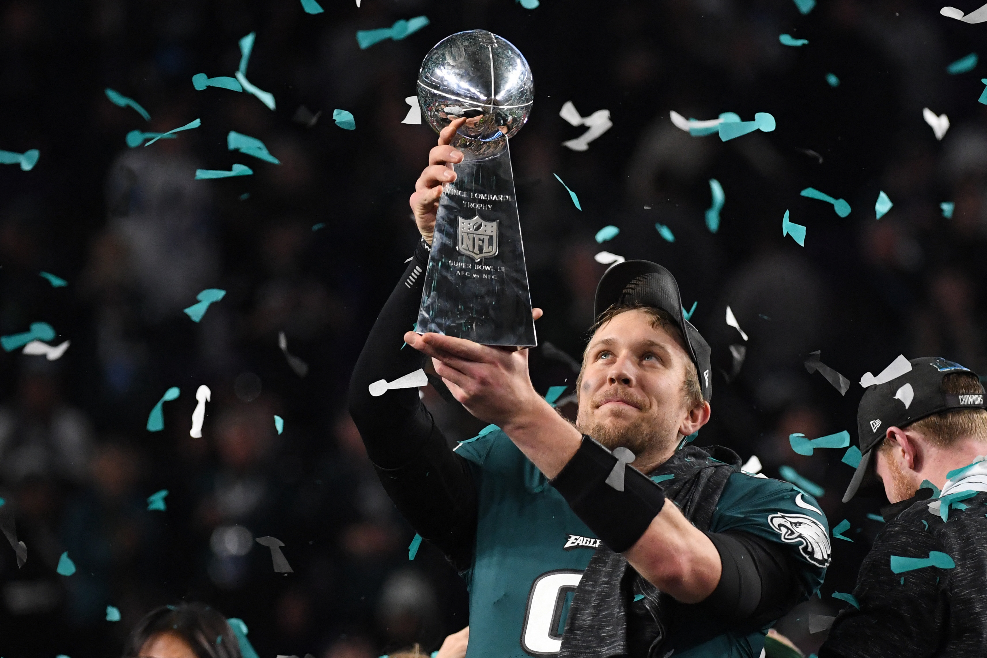 Philadelphia Eagles quarterback Nick Foles raises the Lombardi Trophy after winning Super Bowl LII.