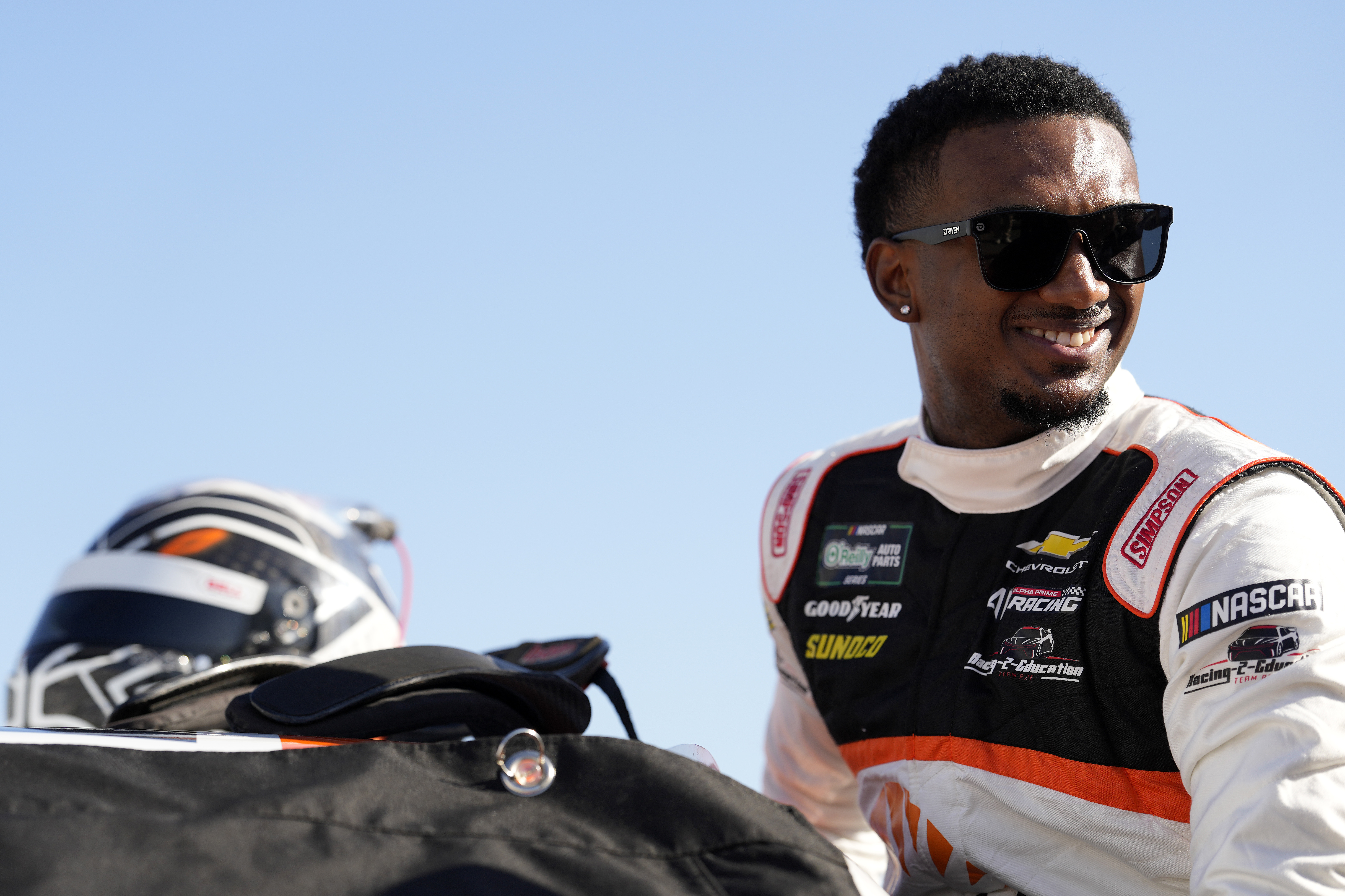 NASCAR driver Lavar Scott enters his car prior to qualifying for the O'Reilly Auto Parts Series United Rentals 300 at Daytona International Speedway.