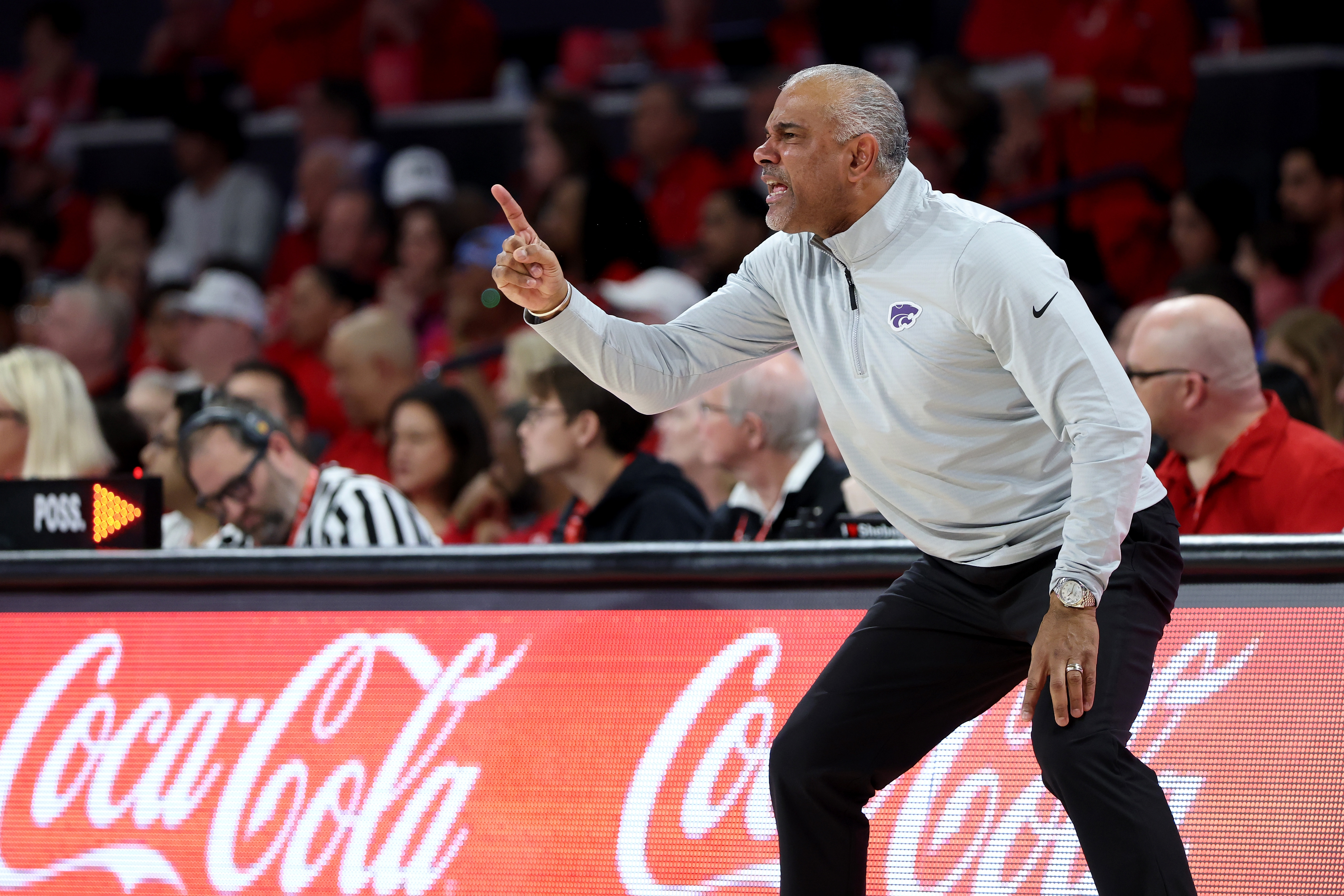 Kansas State head coach Jerome Tang yells during a basketball game. 