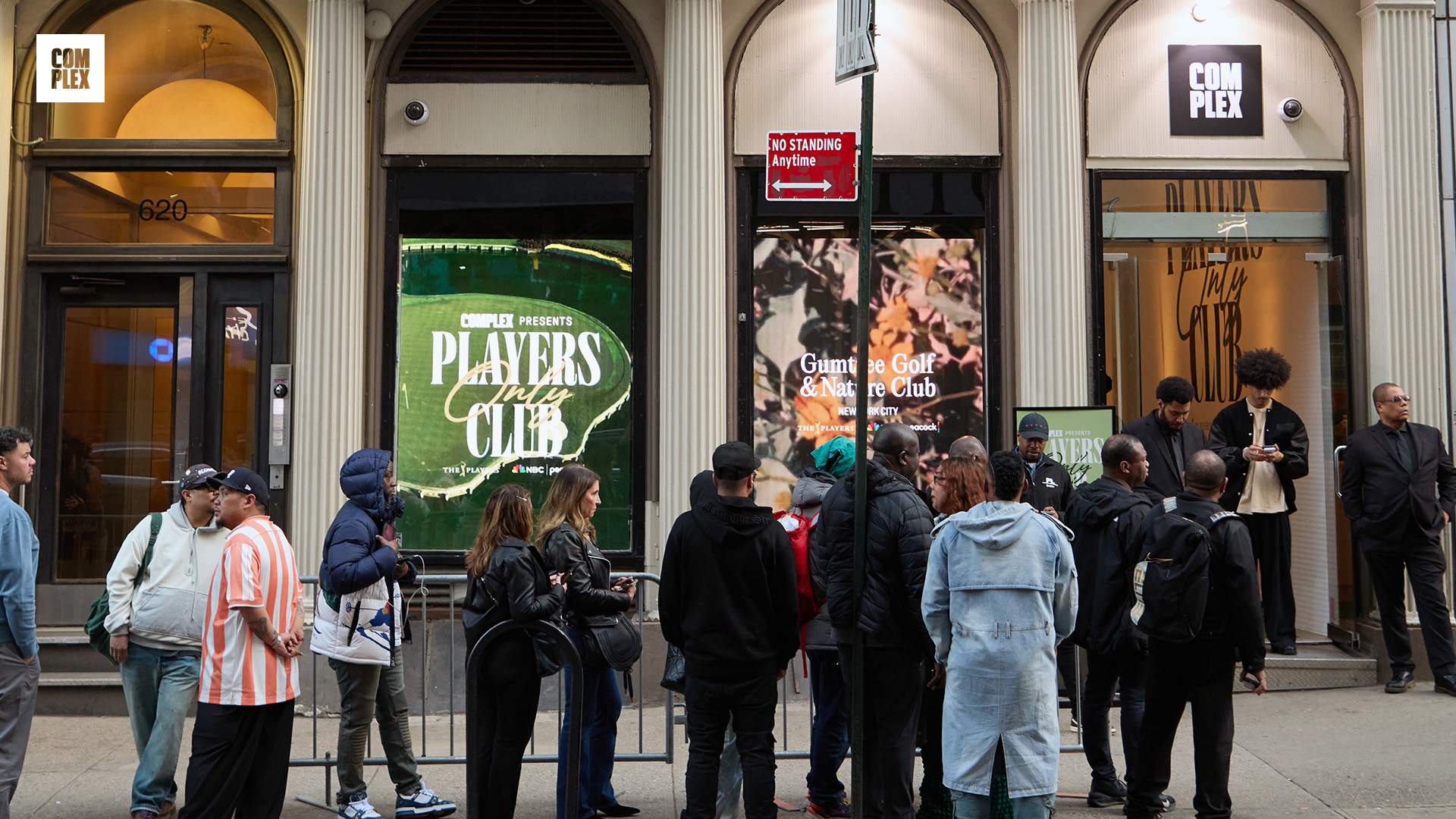 People are gathered outside a building with "Complex" signage. The windows display "Players Club" and "Gunna's Golf & Nature Club" posters.