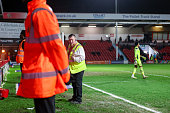 A chief steward stands in front of the goal while supervising the response to a perceived risk during the final minutes of the Sky Bet League 2 match between Walsall and Cambridge United at the Pallet Track Bescot Stadium in Walsall, United Kingdom, on March 17, 2026. (Photo by Stuart Leggett/MI News/NurPhoto via Getty Images)