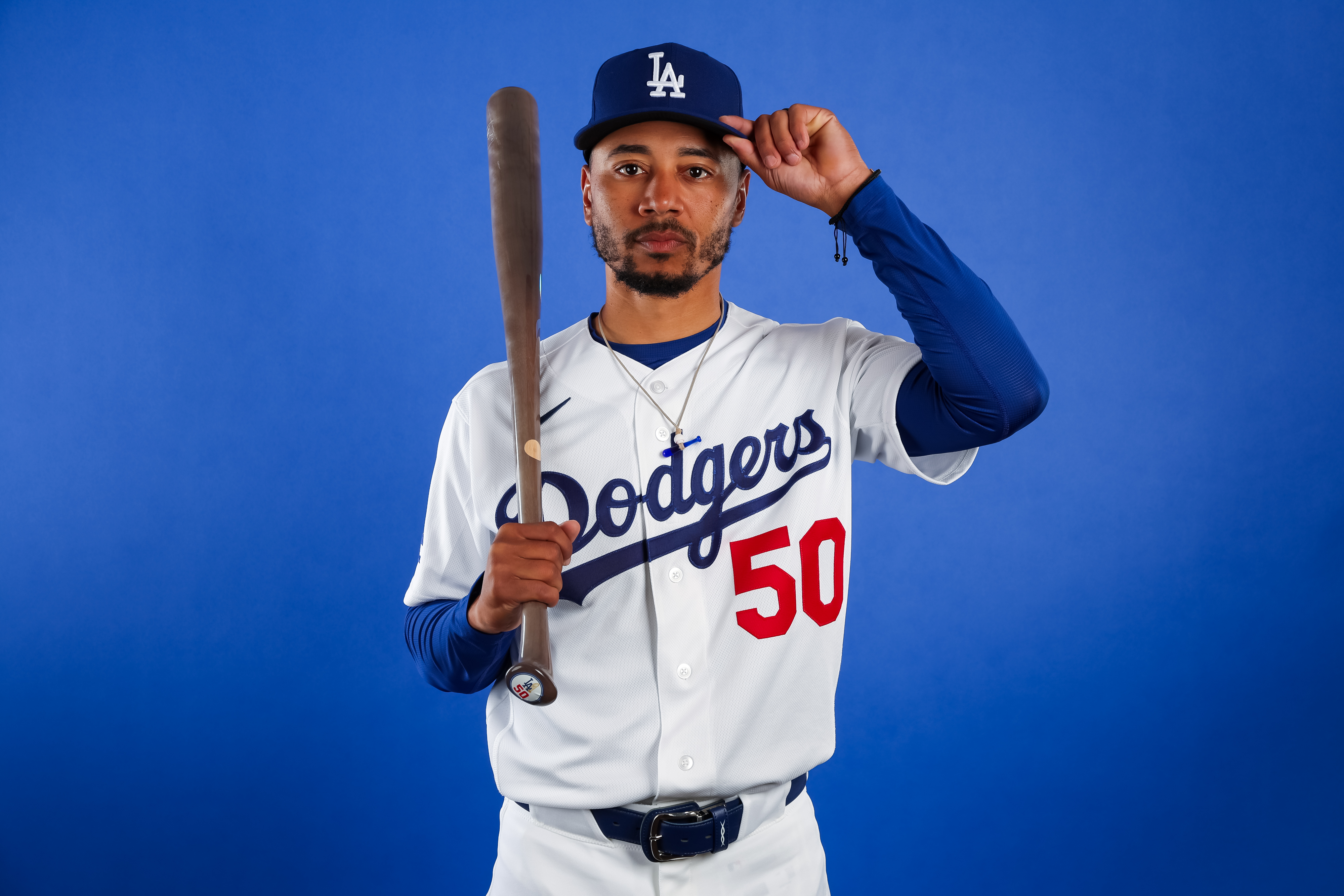 Mookie Betts tips his cap during Dodgers media day photos. 