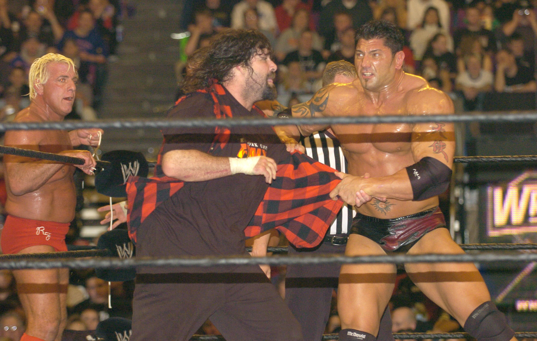 Batista whips Mick Foley into the ropes during the Evolution vs. Rock N Sock Connection match at WrestleMania XX. 