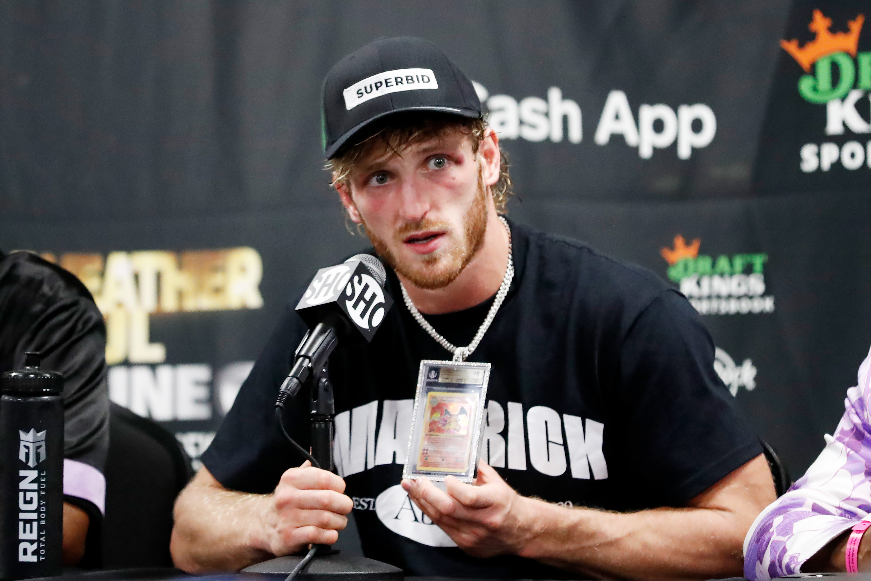 Logan Paul talks about his Charizard Pokemon card chain during his press conference following his contracted exhibition boxing match against Floyd Mayweather at Hard Rock Stadium on June 06, 2021 in Miami Gardens, Florida