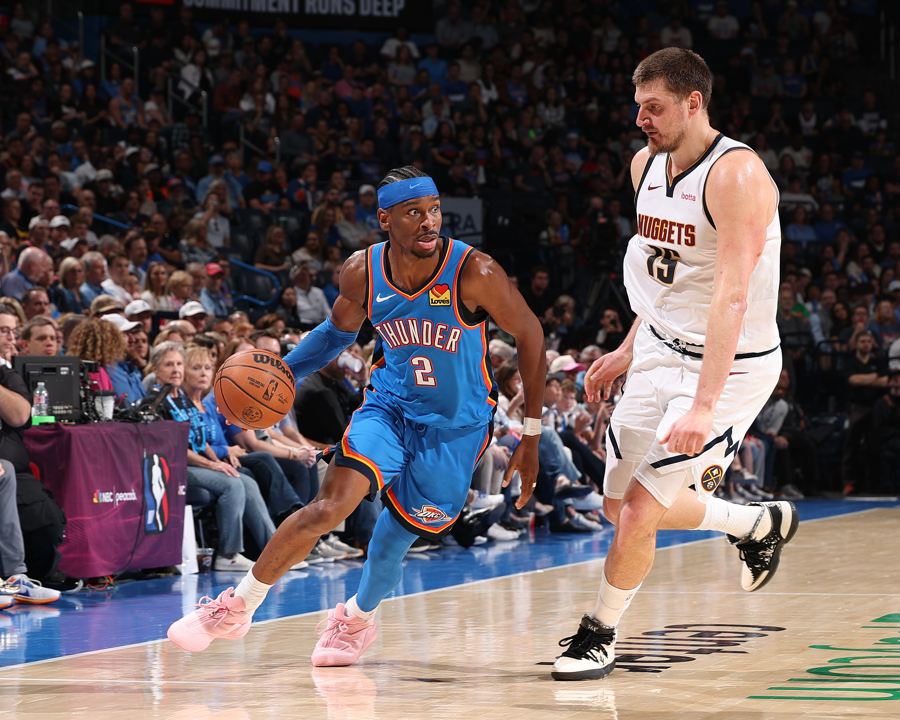 SGA turns the corner on Nikola Jokic during a March 2026 Thunder-Nuggets game. 
