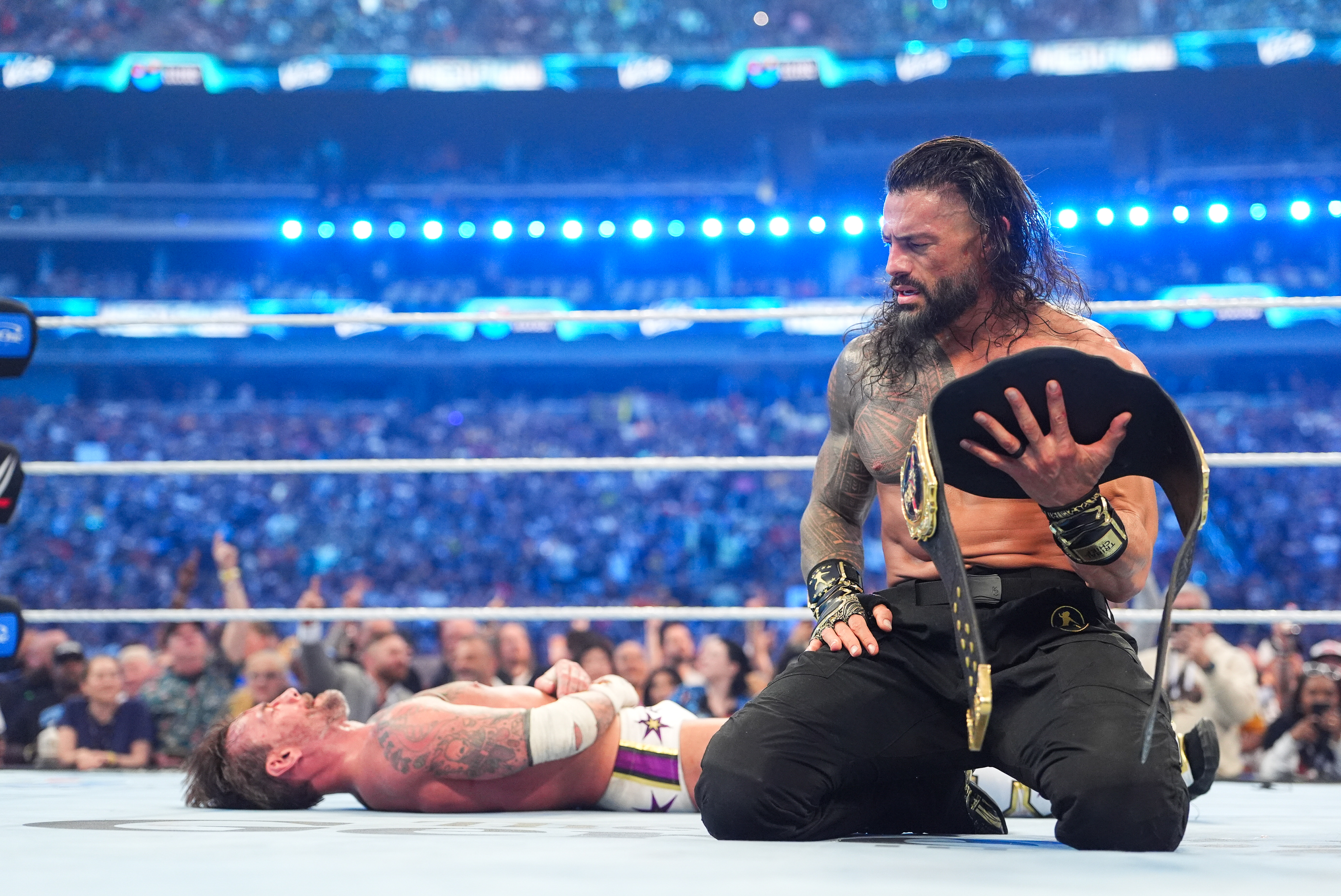 Roman Reigns looks back at CM Punk after pinning him in the main event of WrestleMania 42.