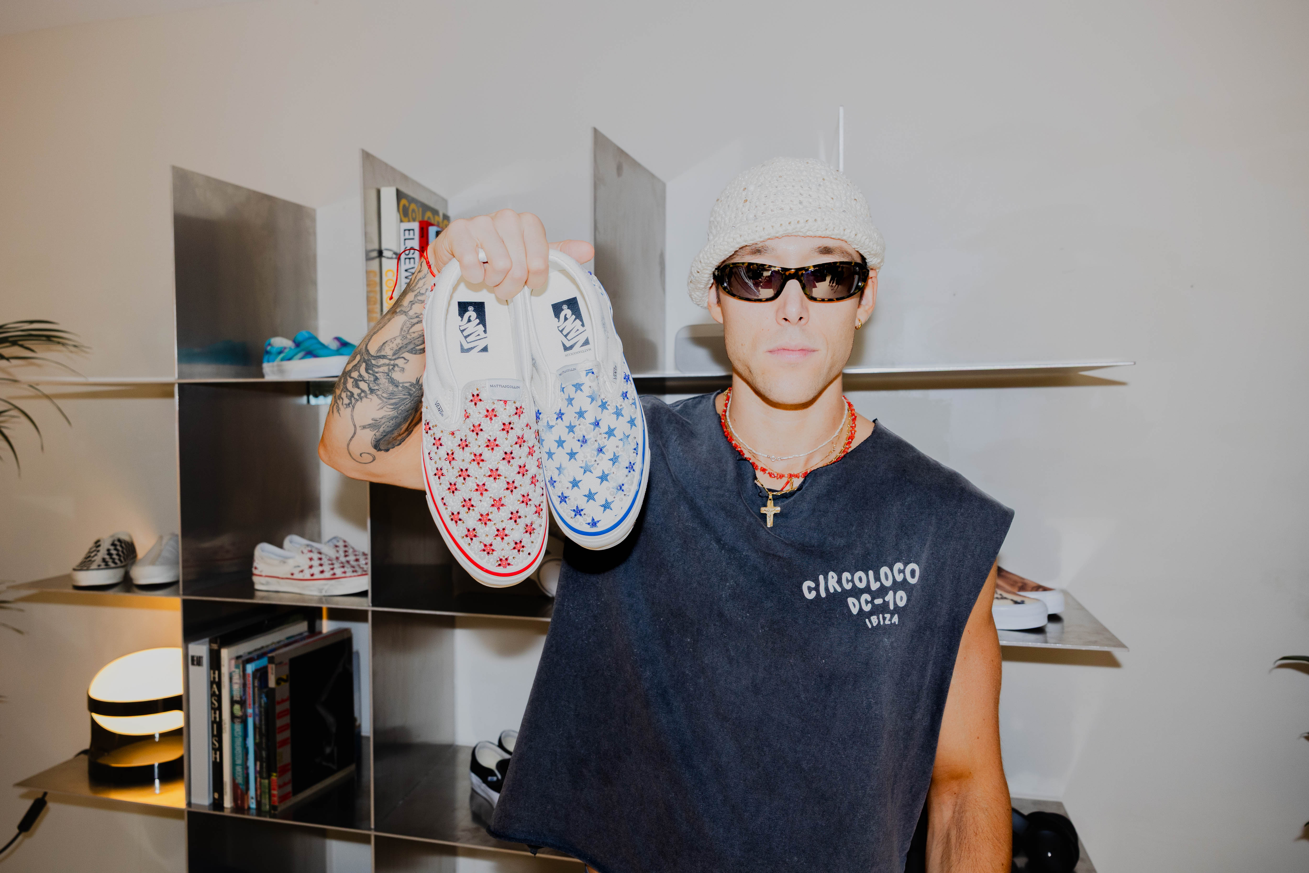 Italian designer Mattias Gollin posing with his two latest Vans Slip-Ons that released exclusively during Paris Fashion Week Men's.