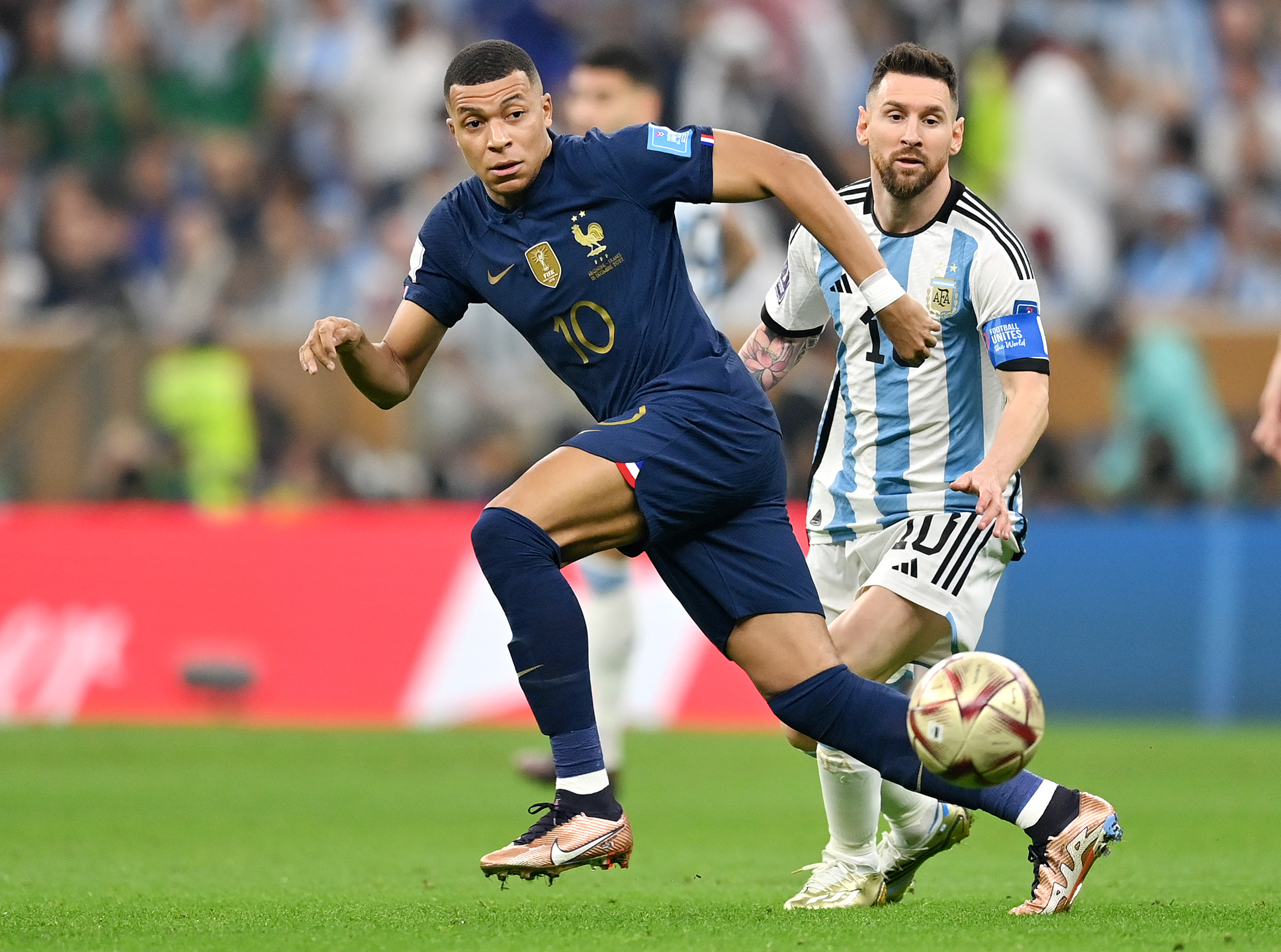 Kylian Mbappe and Lionel Messi chase after the ball during the 2022 FIFA World Cup finals.