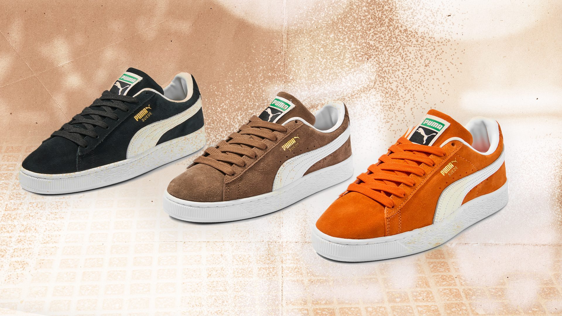 Three Puma sneakers in black, brown, and orange, each with the signature white stripe and logo on a textured background.