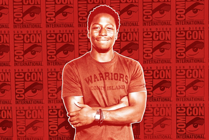 A person smiling with arms crossed at a Comic-Con event, standing in front of a Comic-Con International backdrop.