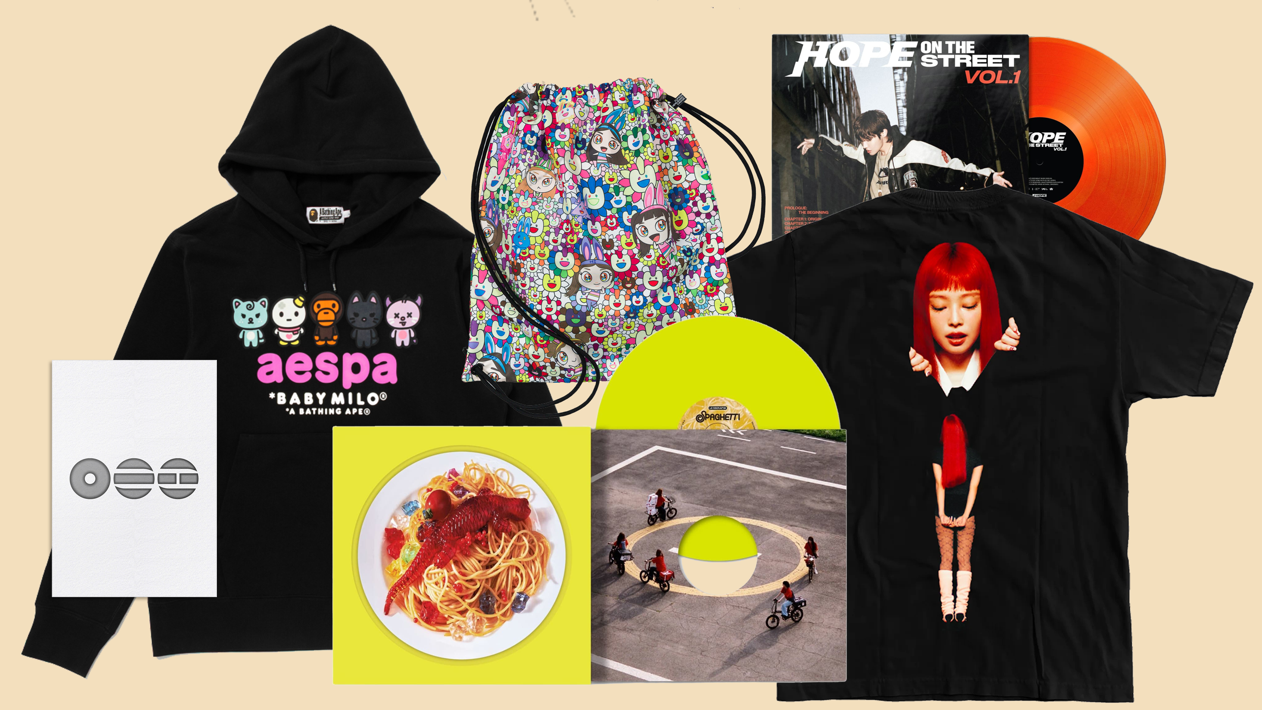 A collection of merchandise including a black hoodie with "aespa" and cartoon characters, a colorful drawstring bag, vinyl records, and graphic tees.