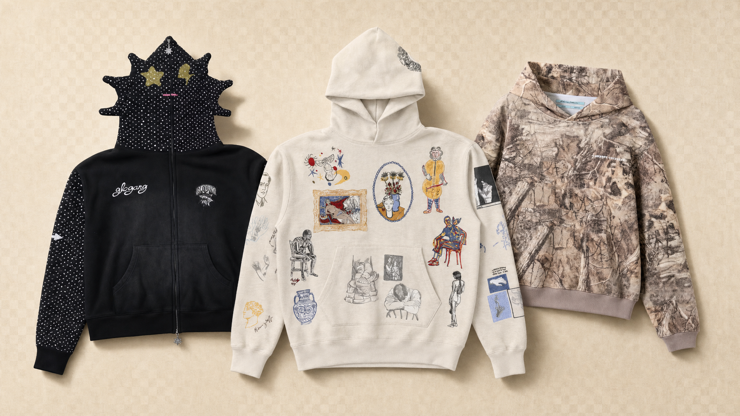 Three unique hoodies: a black one with star-shaped spikes and polka dots, a cream one with eclectic sketches, and a brown one with a nature print.